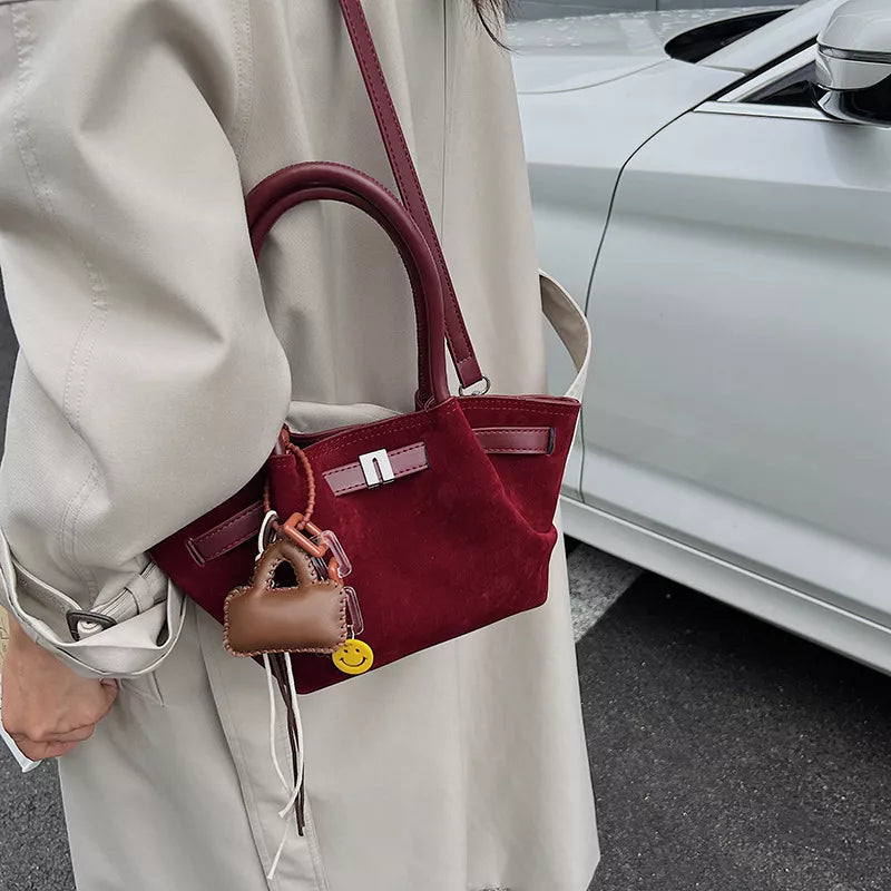 Burgundy suede and leather mini tote bag with charm and smiley face detail