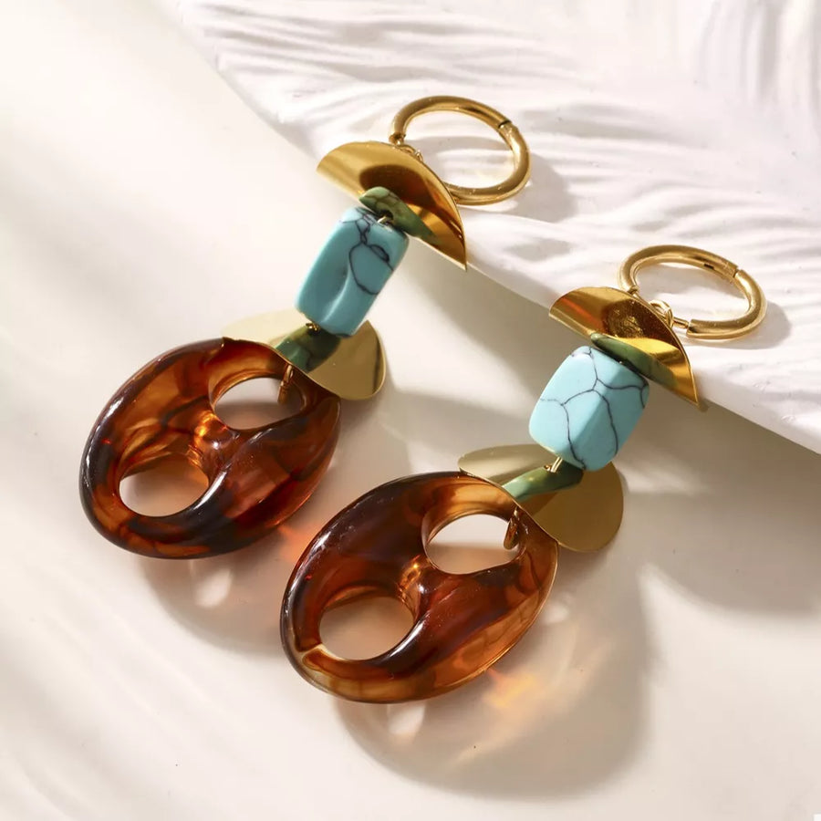gold earrings featuring geometric shapes and geometric