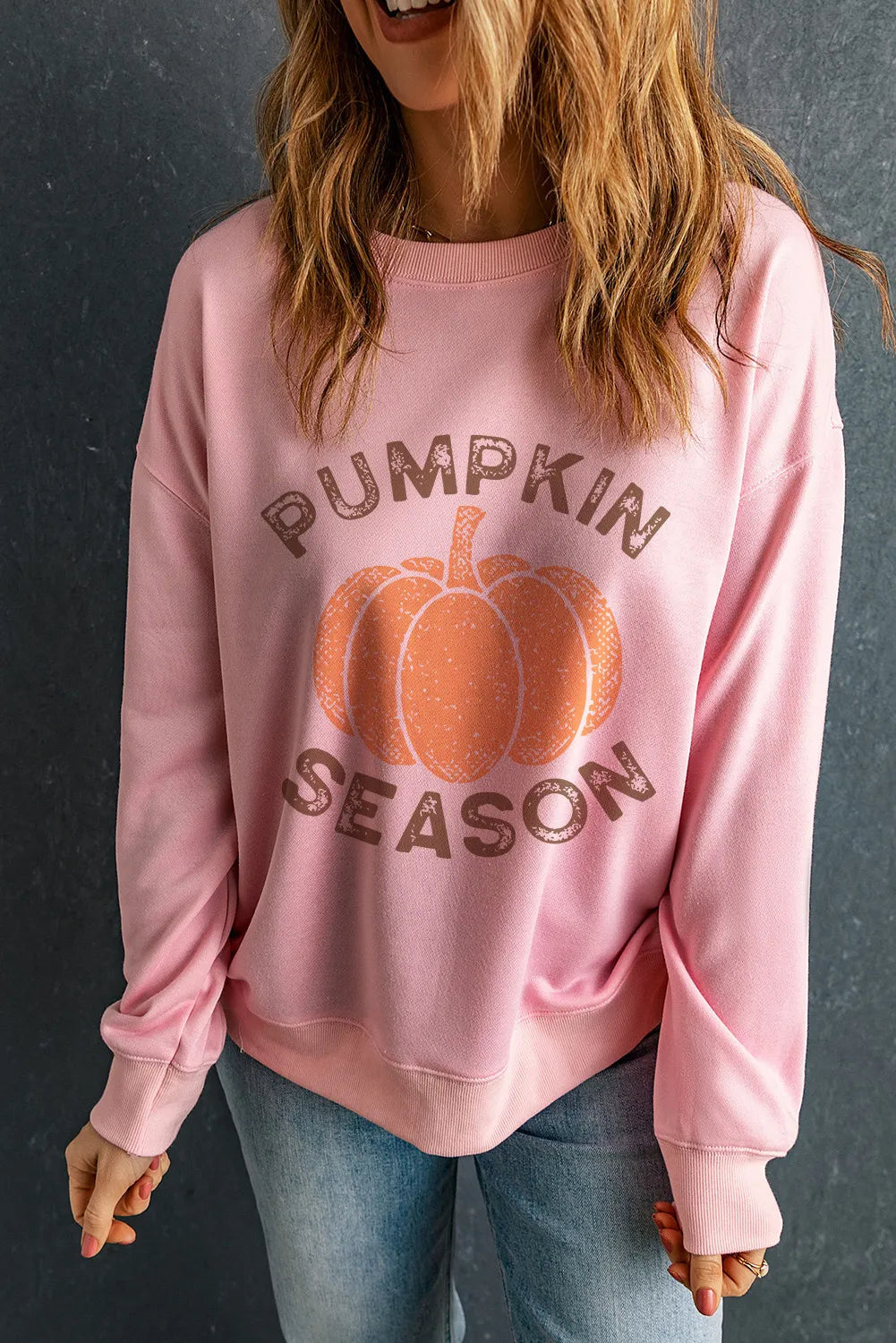 Pink crewneck sweatshirt with pumpkin graphic and text reading Pumpkin Season