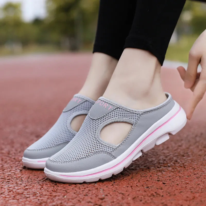 Gray mesh mule slippers with cut-out detail and pink accents