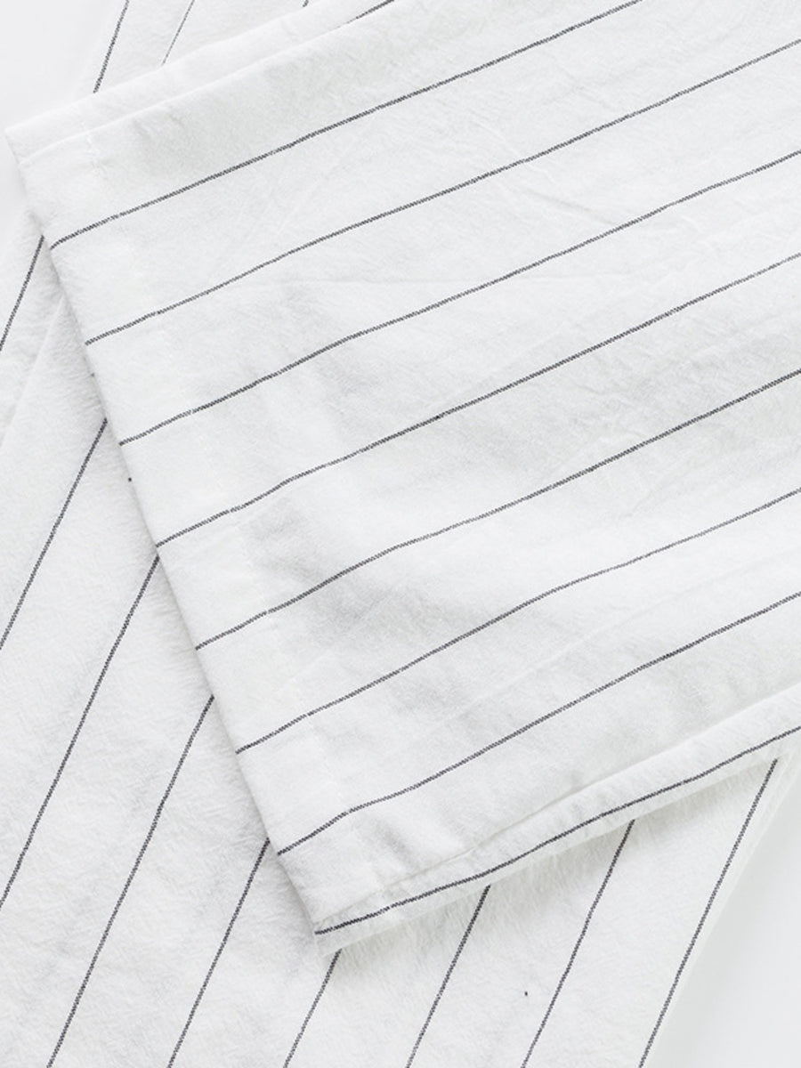 White men's sweatpants with thin black pinstripes and a wide-leg cut.