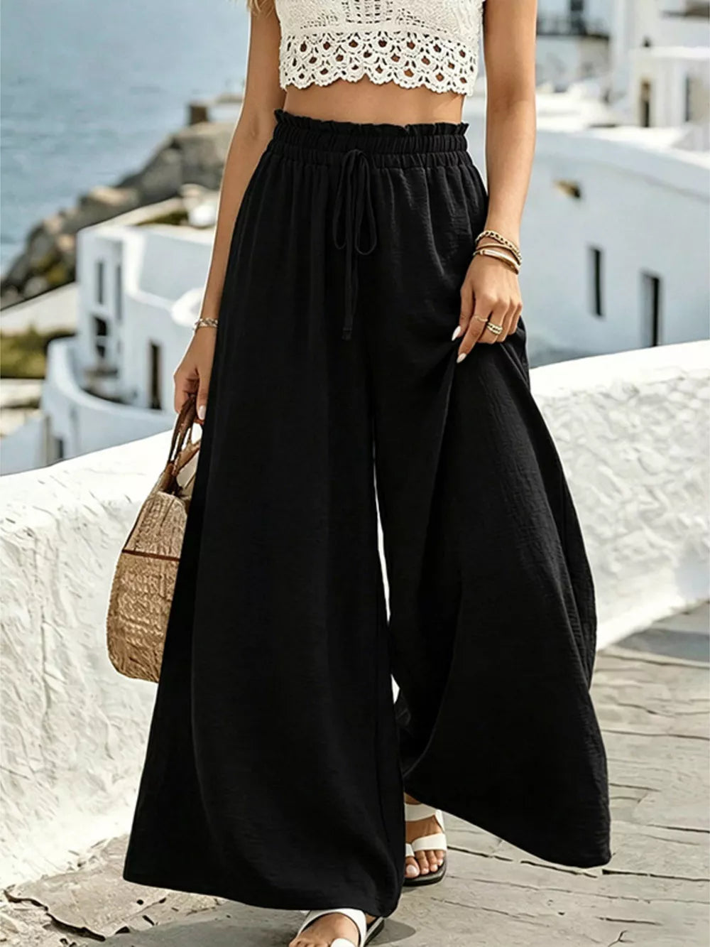 Black wide-leg linen pants with drawstring waist and textured fabric