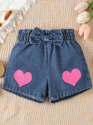 Denim shorts with pink hearts and a bow detail.