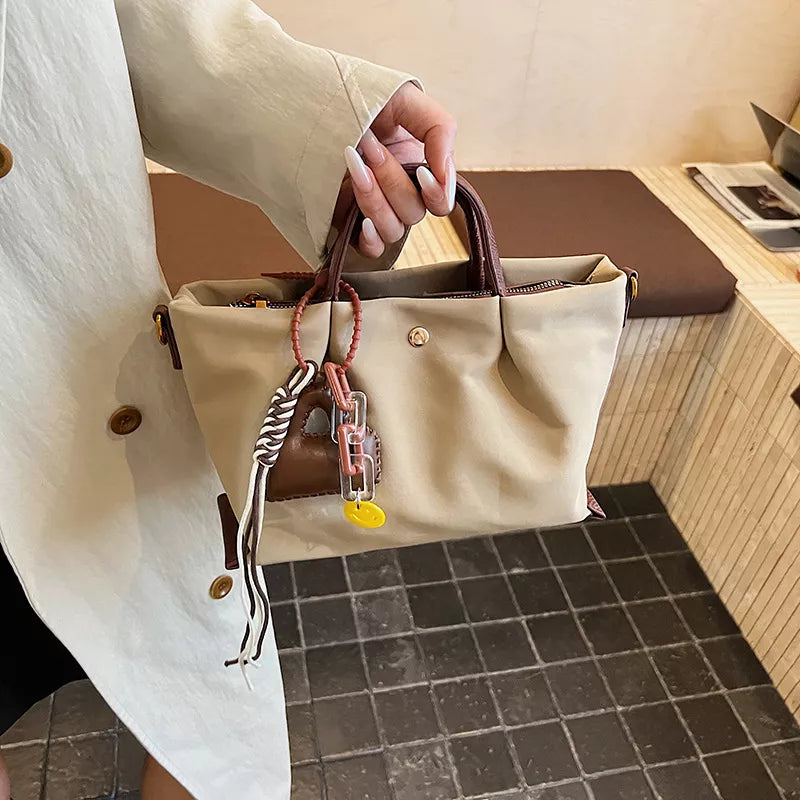 Compact nylon handbag in Khaki with leather accents and playful charms.