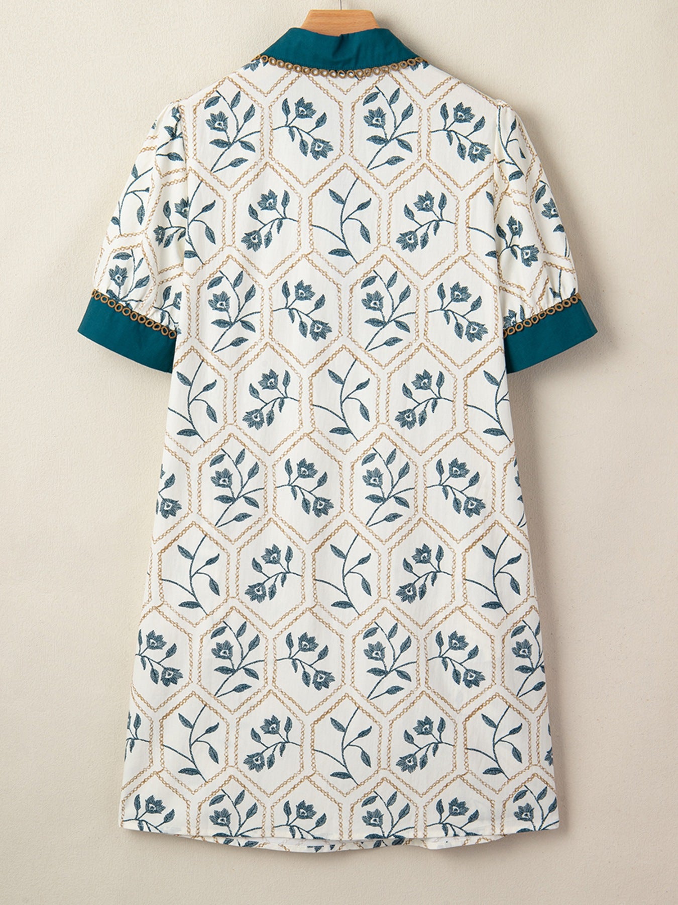 Floral print polo collar mini dress with teal trim and gold chain detail