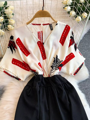 White abstract print wide-leg romper with black bottom and pockets