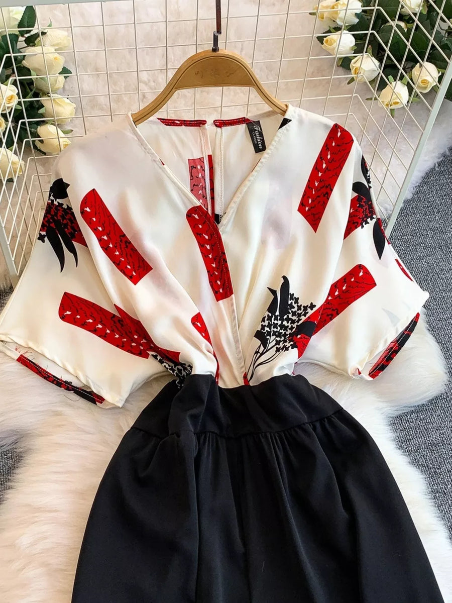 White abstract print wide-leg romper with black bottom and pockets