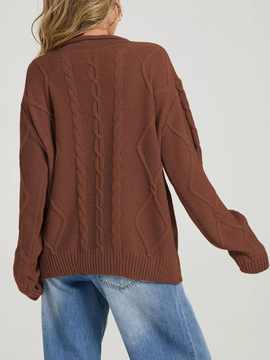 Black pullover sweater featuring cable-knit and cable knit
