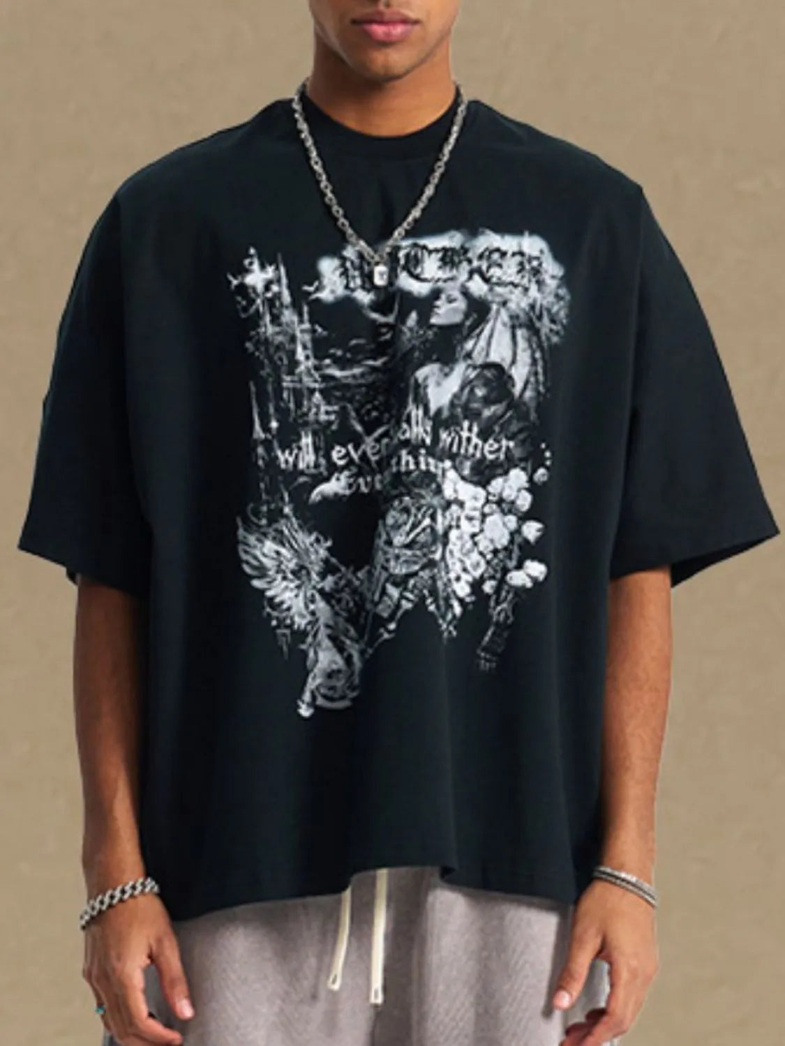 Black oversized graphic tee with gothic print and crew neck.