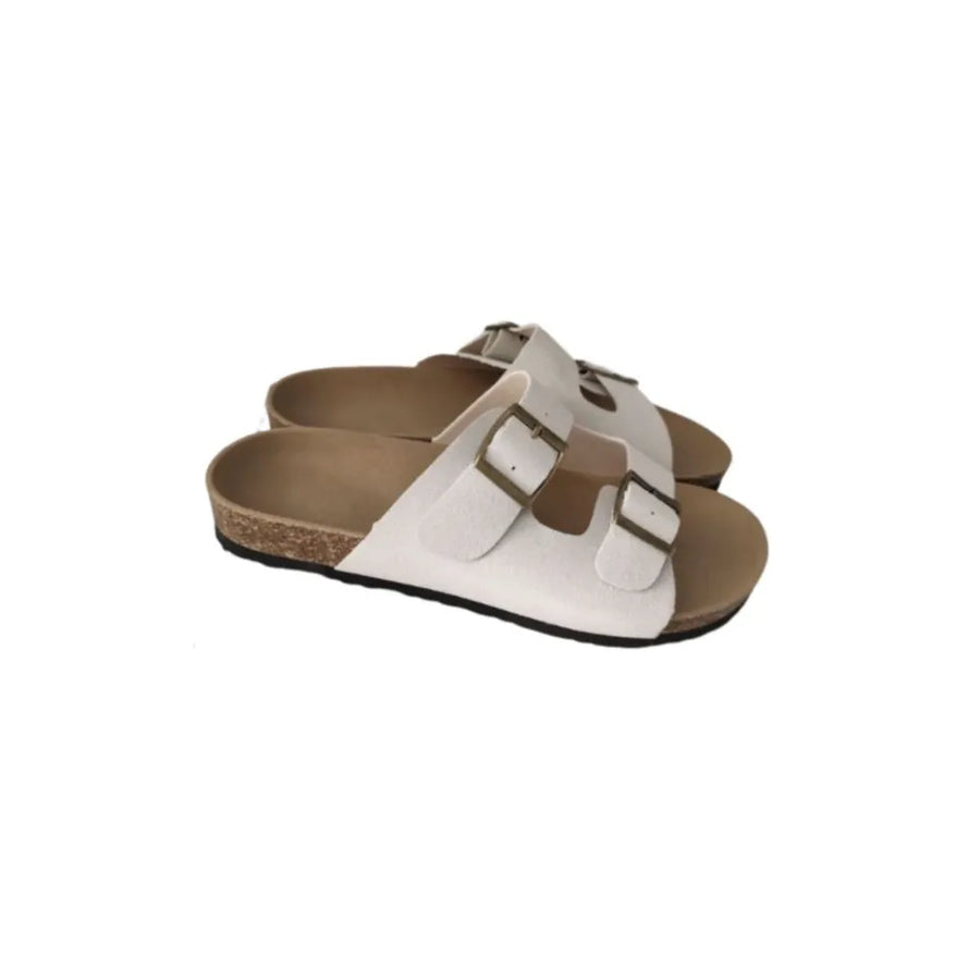 White suede slide sandals with double adjustable buckles and cork sole.