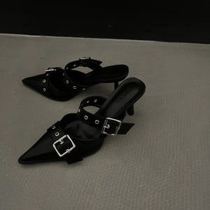 Black pointed buckle mules with silver hardware and double straps.