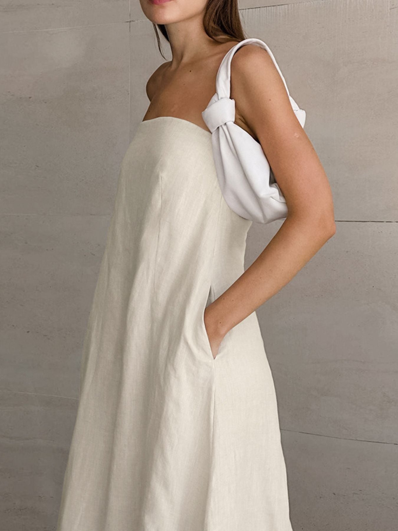 Beige cotton smocked tube dress with a-line cut and pockets.