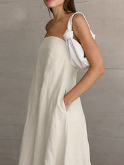 Beige cotton smocked tube dress with a-line cut and pockets.