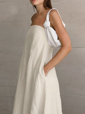 Beige cotton smocked tube dress with a-line cut and pockets.
