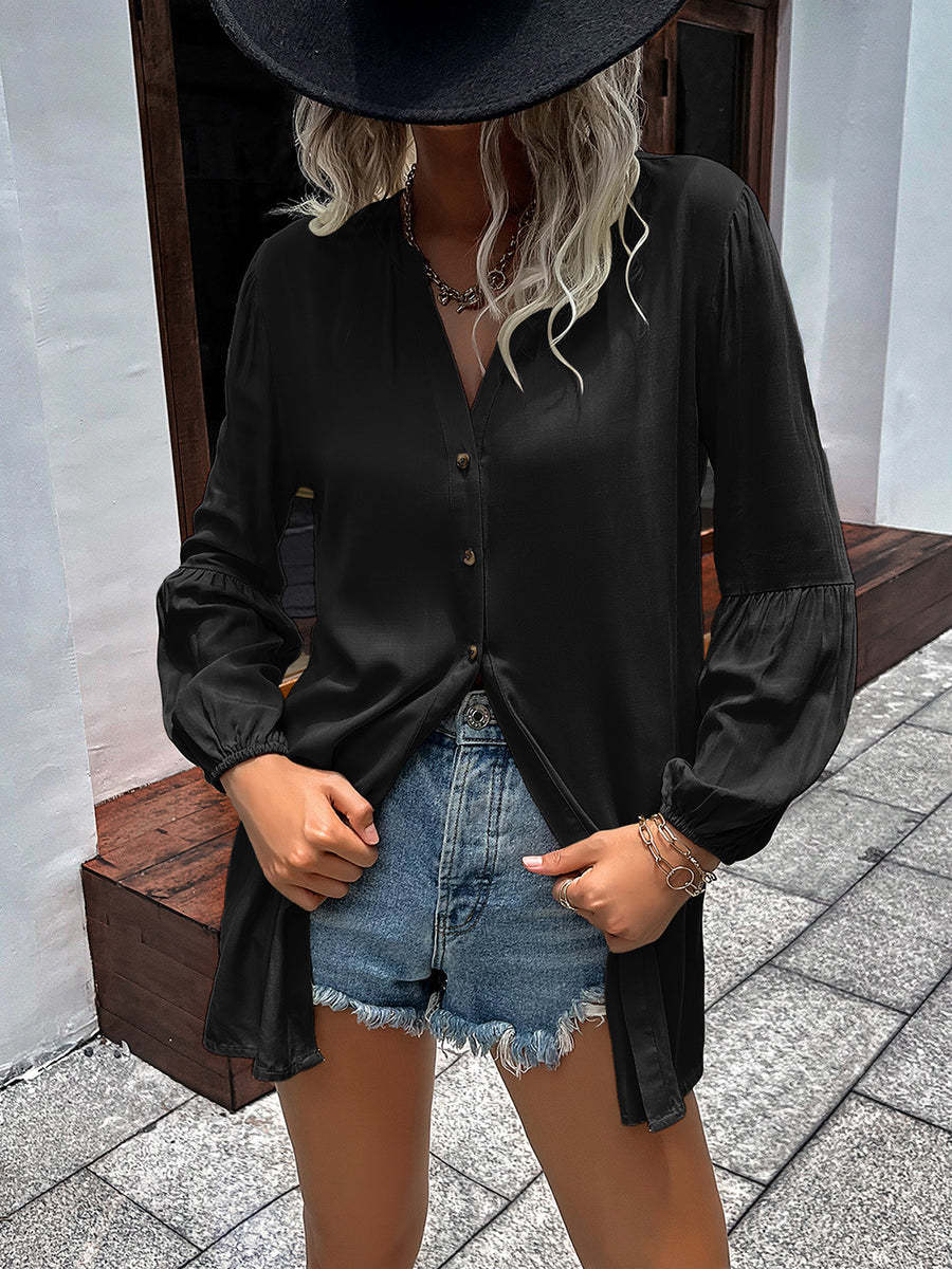 Black oversized blouse with Mandarin collar, button front, and balloon sleeves.