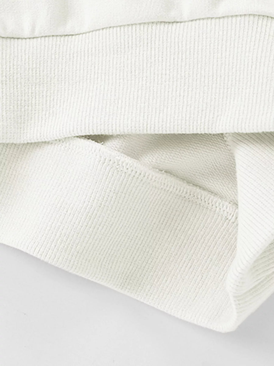 White cotton crew neck sweatshirt detail showing ribbed cuffs and hem.