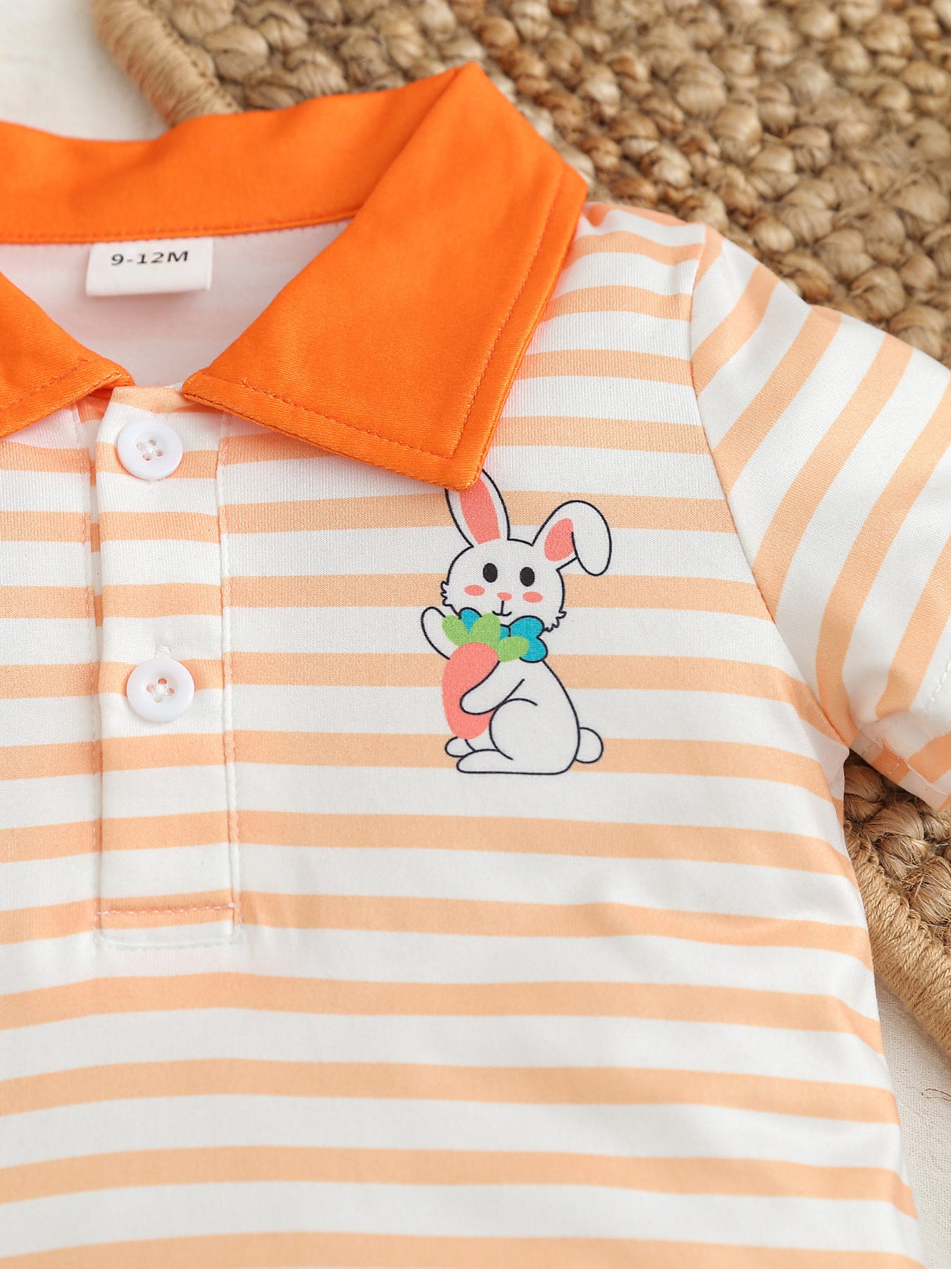 Children's orange and white striped polo shirt with bunny graphic and orange collar.