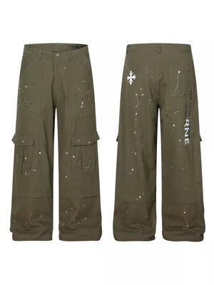 Olive green cotton cargo pants with white paint splatter design and button fly.