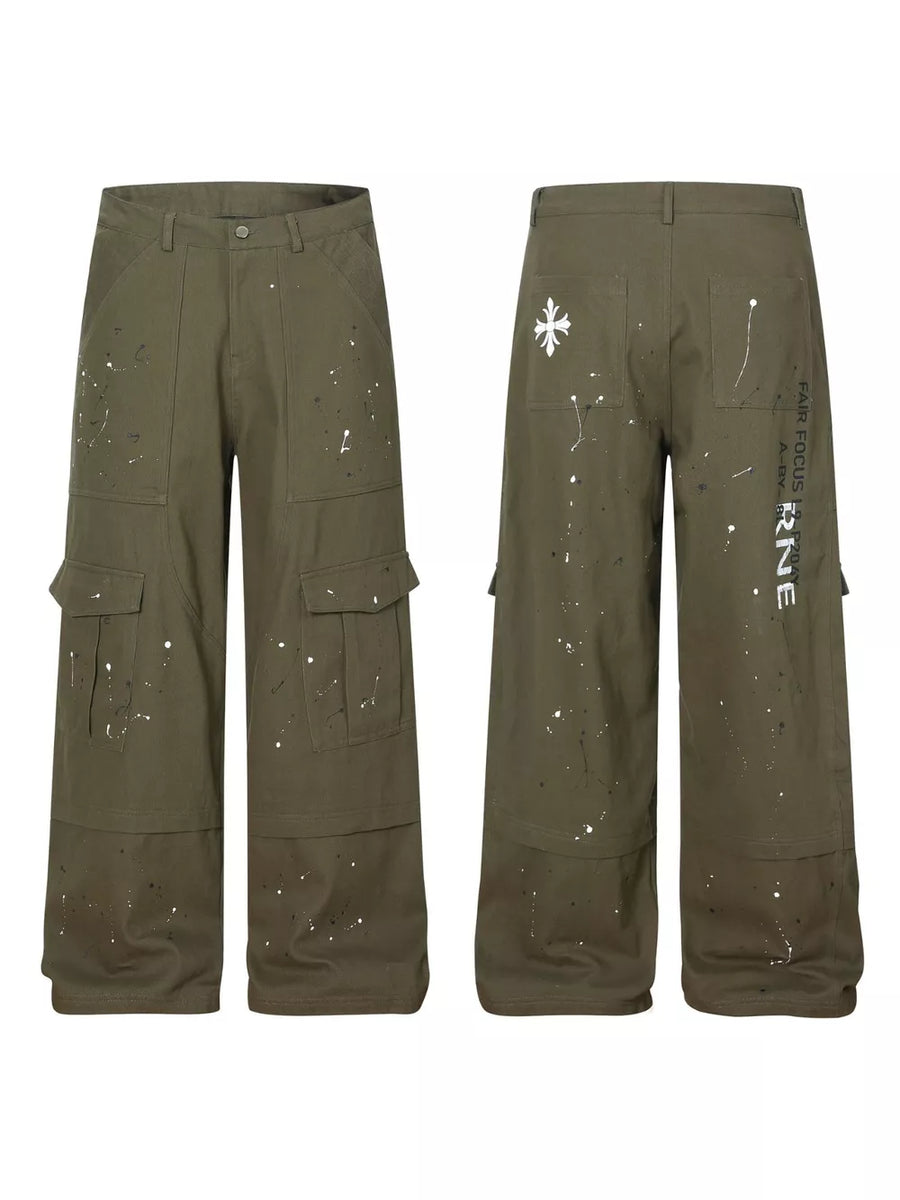 Olive green cotton cargo pants with white paint splatter design and button fly.