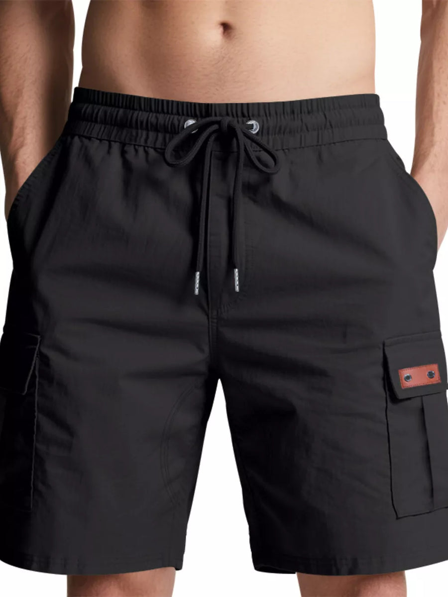 Black cargo shorts with drawstring waist and buttoned flap pockets.