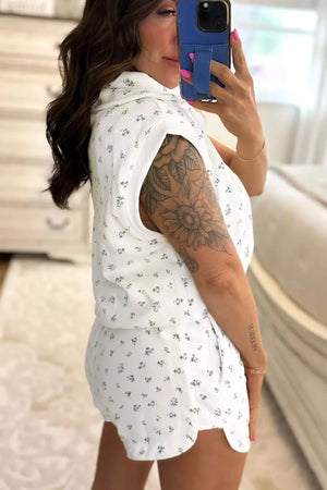 White floral print pajama set with collared sleeveless top and scalloped hem shorts