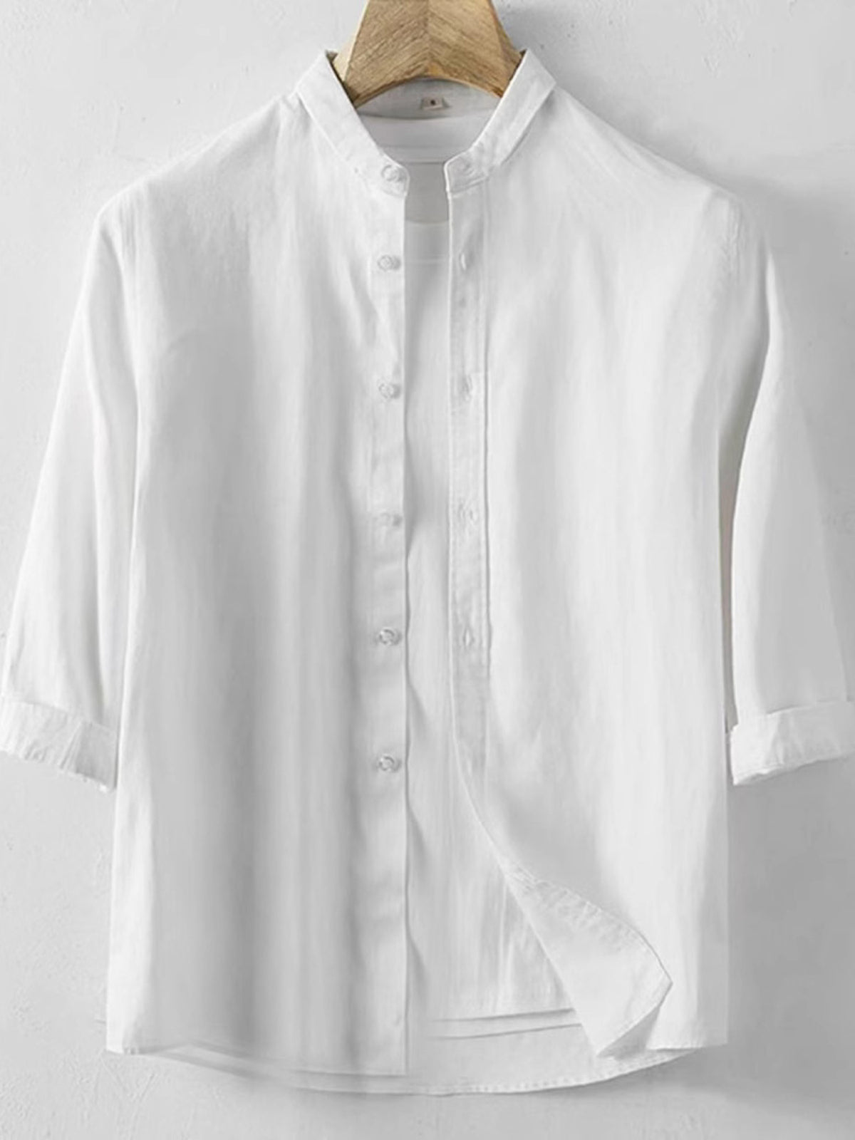 White linen band collar shirt with 3/4 sleeves and button front.