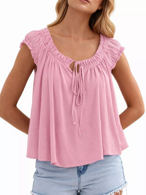 Pink tie-front gathered blouse with short sleeves and a drawstring neckline.