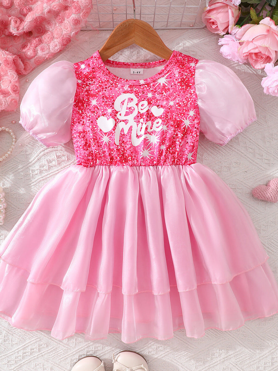 Pink sequin baby dress with puff sleeves and "Be Mine" graphic, tiered skirt.