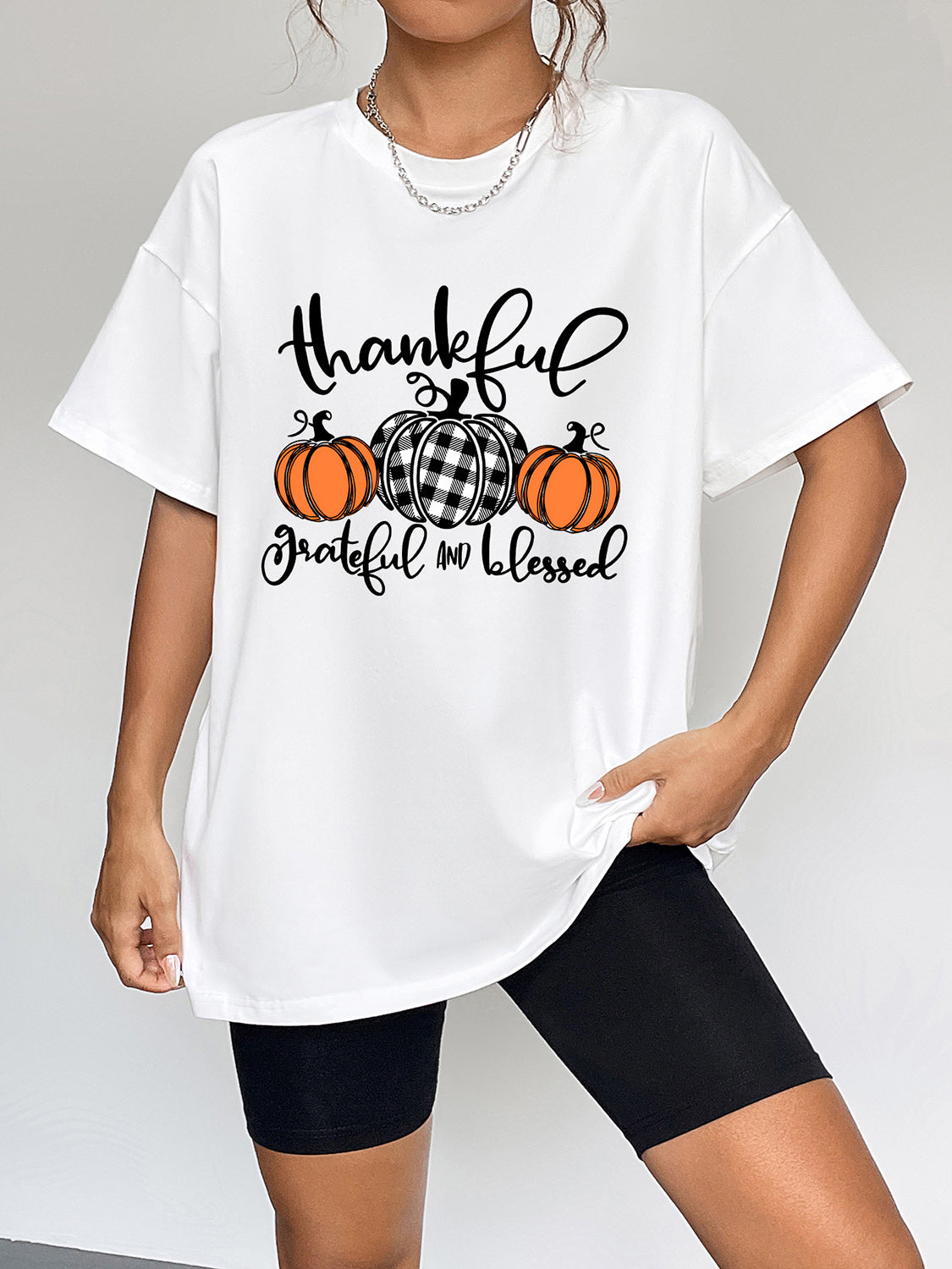 White oversized graphic tee with thankful grateful blessed pumpkin print