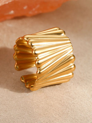 Gold ring featuring wide band and geometric