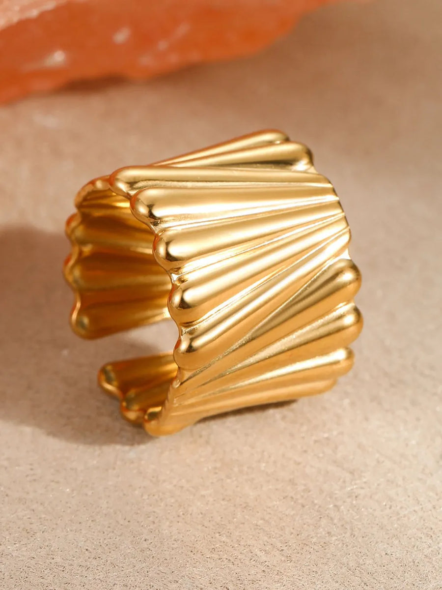 Gold ring featuring wide band and geometric
