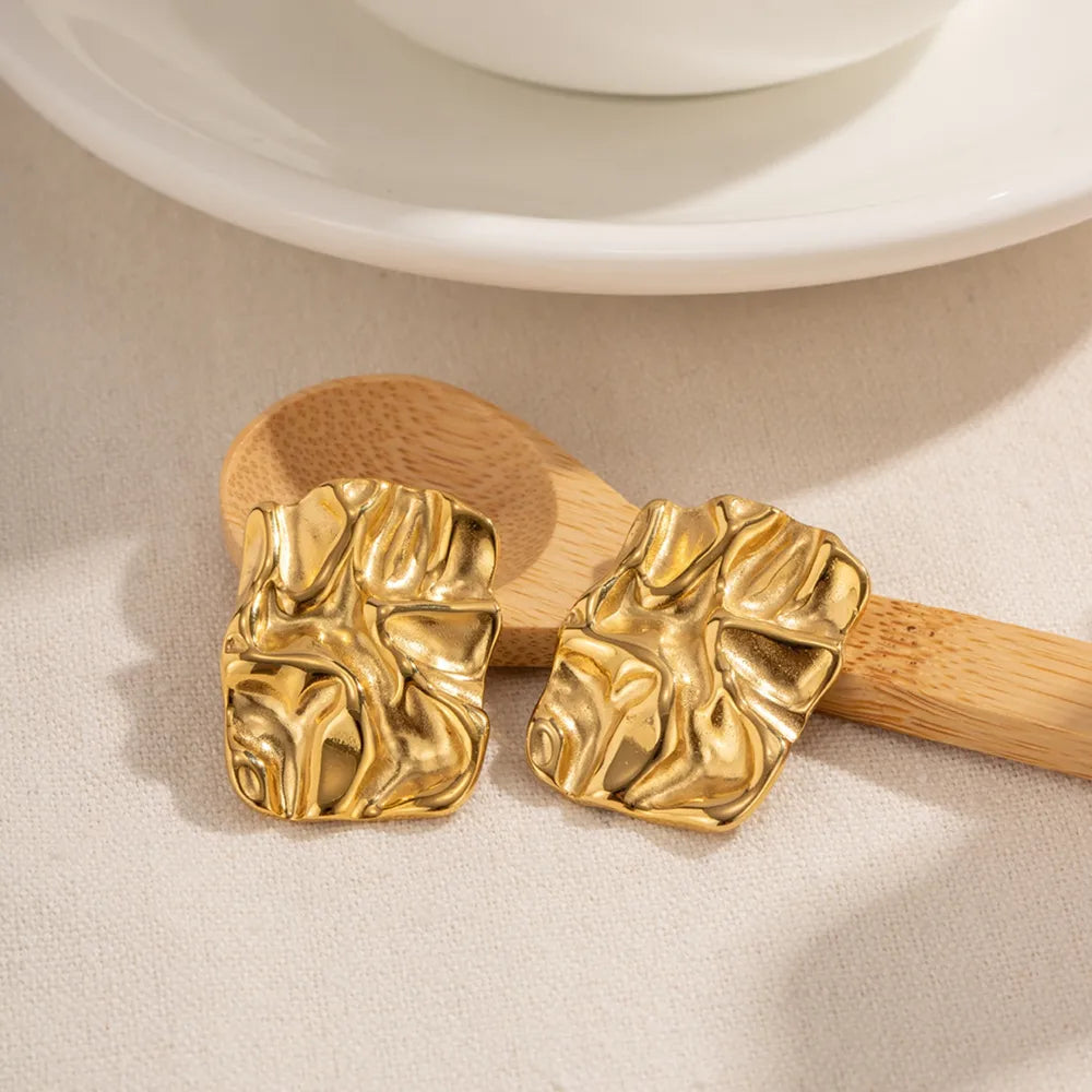Textured gold sculptural stud earrings with 18K gold plating.
