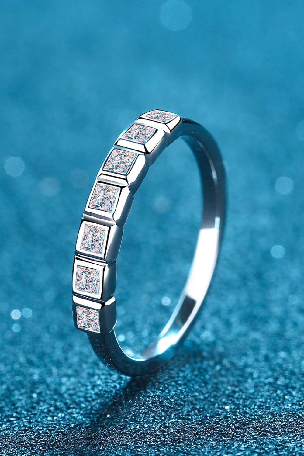Silver band ring with square cut diamonds set in a row