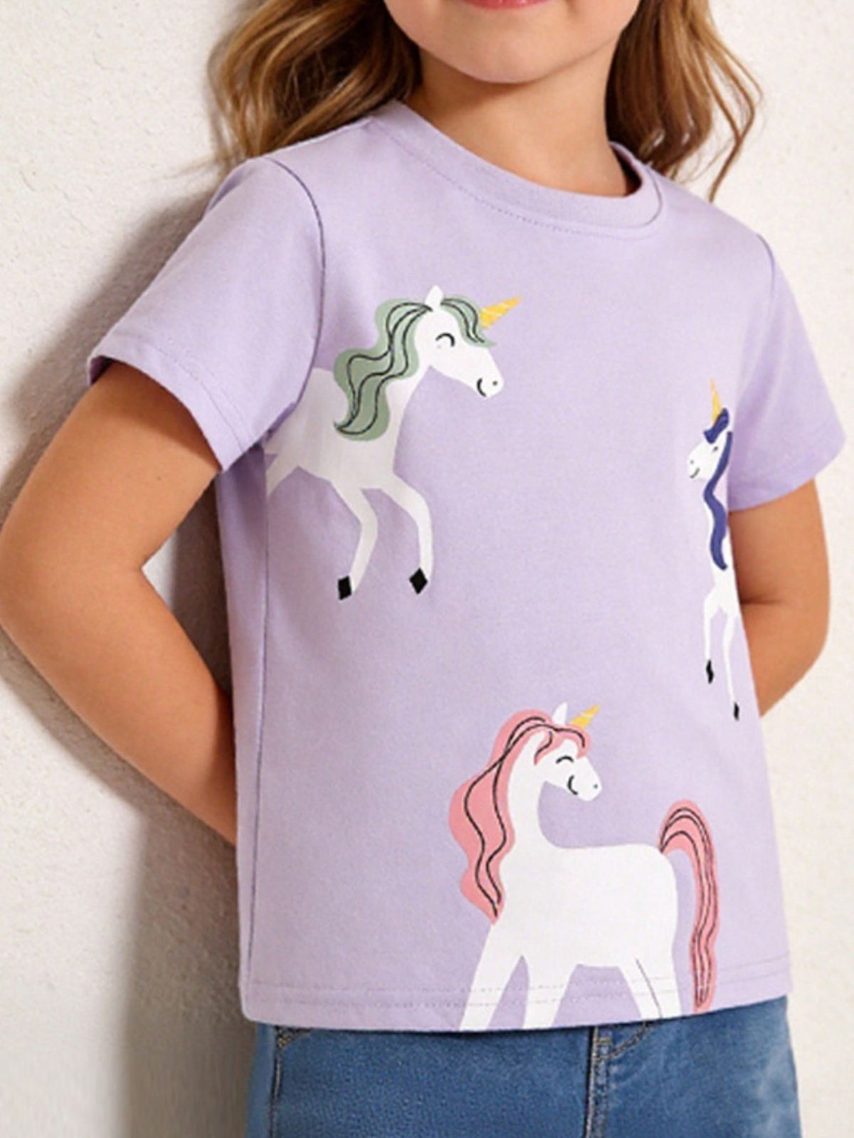 Toddler lilac cotton t-shirt with a casual fit and a whimsical unicorn graphic print.