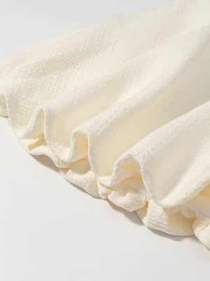Textured cream bubble hem dress with buttoned top detail