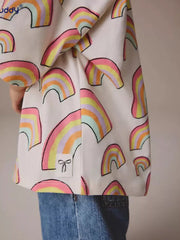Toddler t-shirt with pastel rainbow print, cotton, crewneck, and bow detail tag.