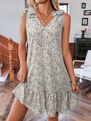 Floral tie strap mini dress in off-white with ruffled hem and v-neckline.