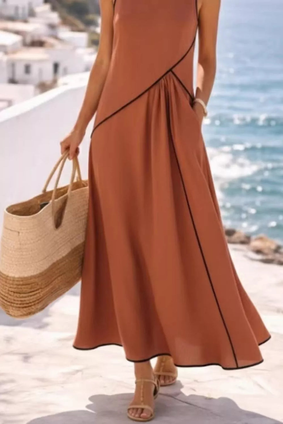 Caramel maxi dress with black contrast piping and a flowing skirt.