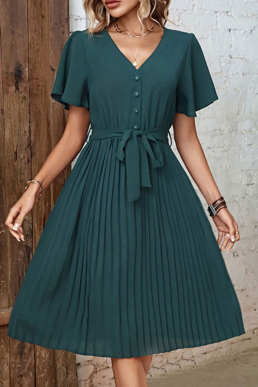Forest green midi dress with flutter sleeves, V-neck, buttons, and a tie belt.