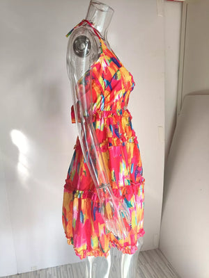 Abstract print halter mini dress with tiered ruffles and a vibrant multicolor pattern.