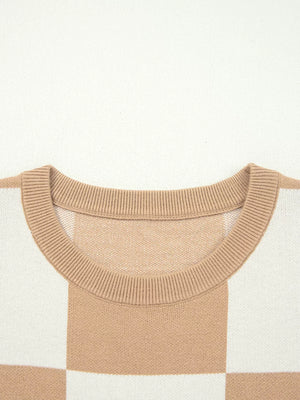 Drop shoulder sweater in camel and white checkerboard pattern with a ribbed crew neck.