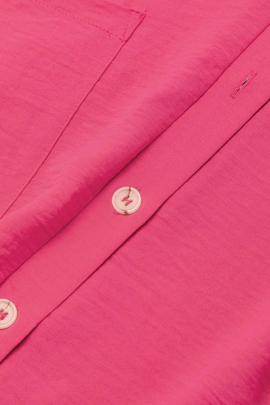 Hot Pink oversized shirt romper with button detail and pocket flap.
