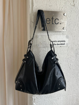 handbag in black featuring rivet decor and relaxed fit