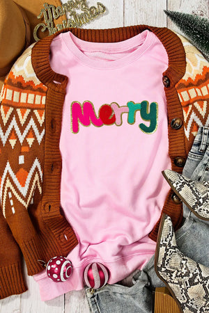 Blush pink crewneck sweatshirt with embroidered colorful "Merry" text and gold trim.