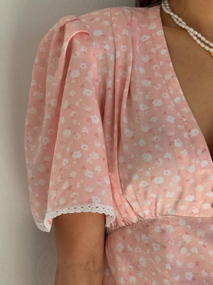 Pink floral puff sleeve dress with lace trim and V-neckline