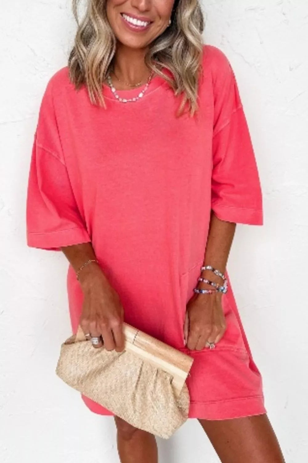 Coral cotton blend t-shirt mini dress with crew neck and drop shoulders.
