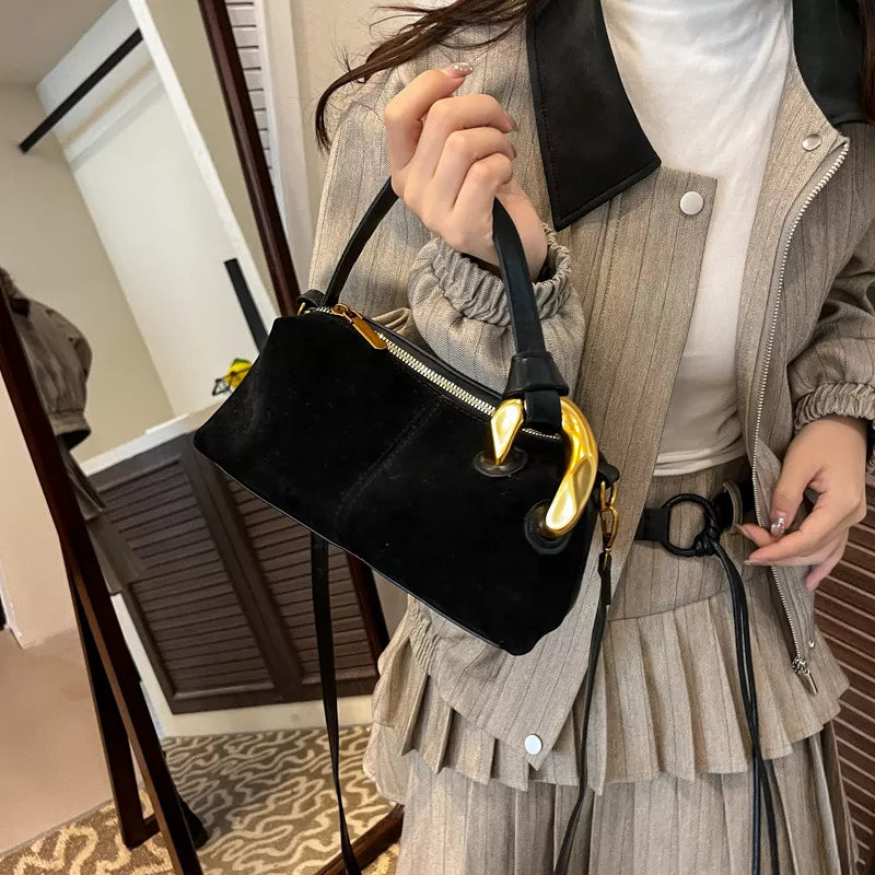 Black suede crossbody bag with gold hardware and zipper detail
