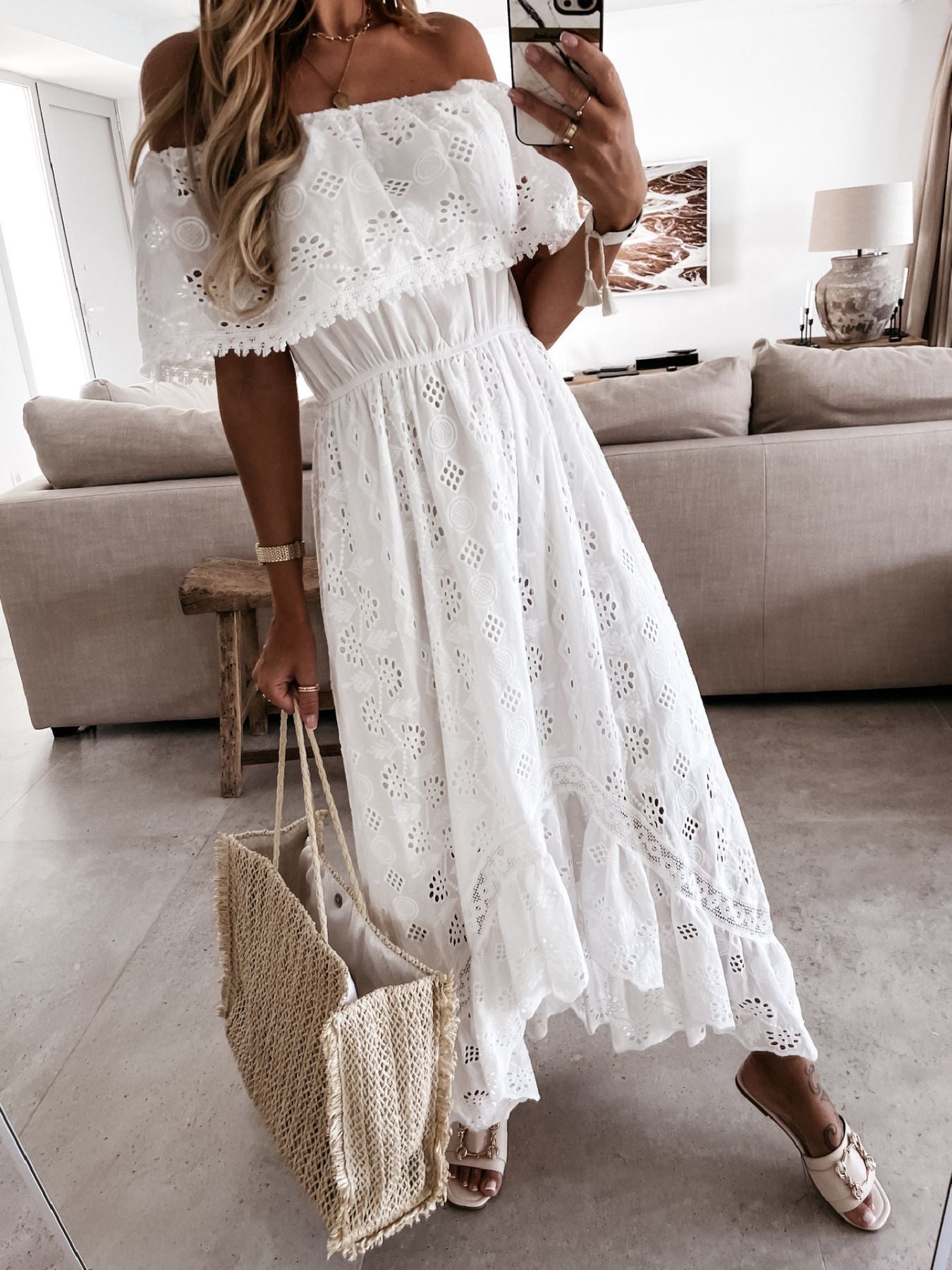 White eyelet lace off-shoulder maxi dress with tiered ruffle hem and elastic waist.