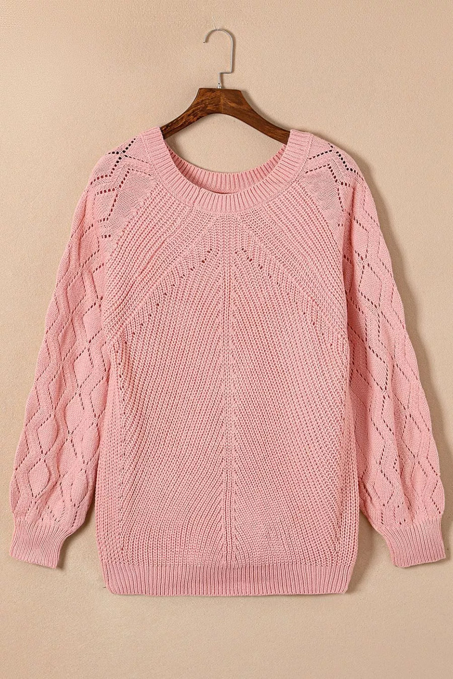 Dusty pink knit sweater with hollow-out diamond pattern on puffy sleeves and yoke.