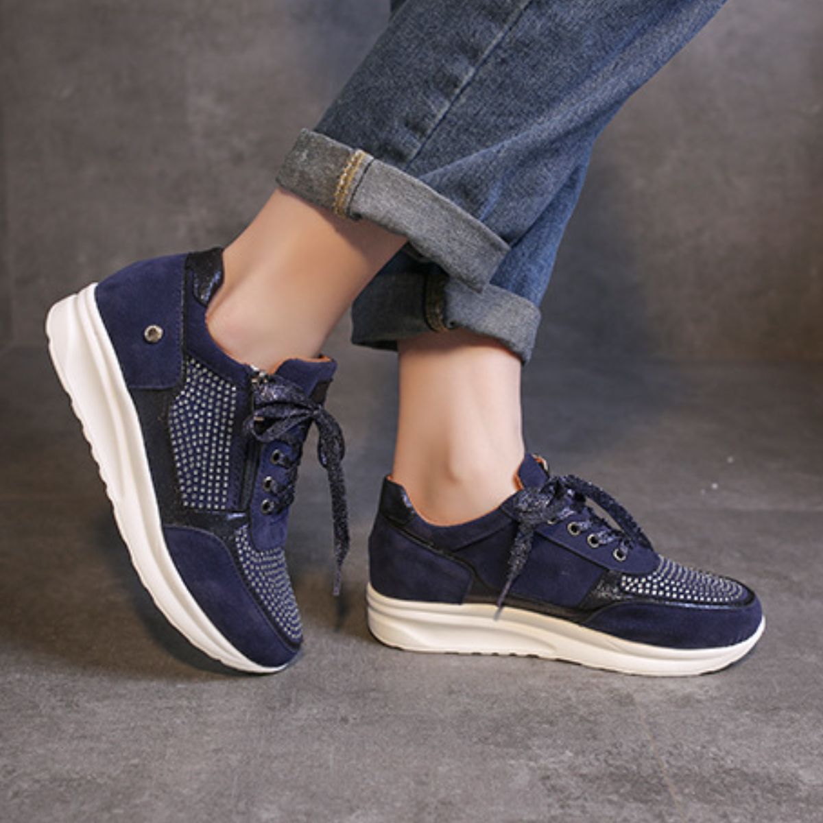 Blue lace-up sneakers with rhinestone embellishments and a chunky sole.